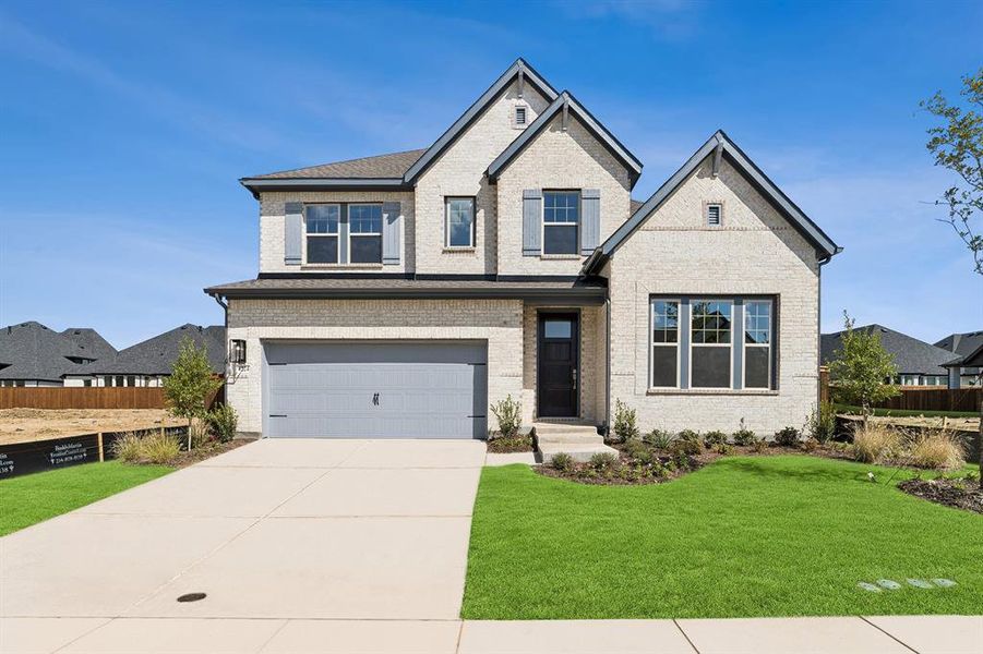 Front exterior of a new home in Sandbrock Ranch, Aubrey, TX, highlighting curb appeal (Image 1).