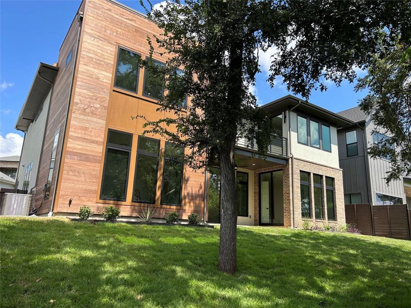 Front exterior of a new home in The Grove, Austin, TX, highlighting curb appeal (Image 1). Front exterior of a new home in The Grove, Austin, TX, highlighting curb appeal (Image 1).