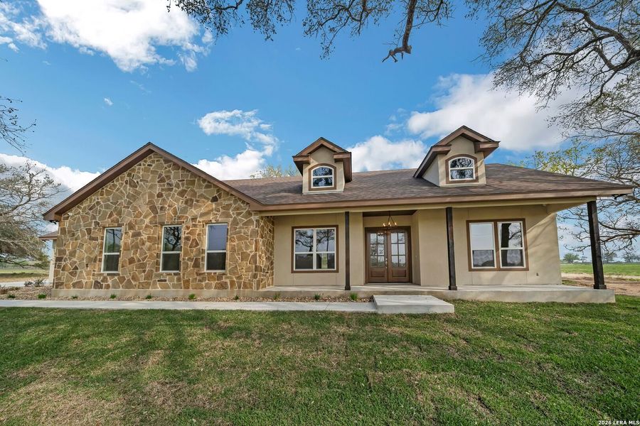 Front exterior of a new home in , Floresville, TX, highlighting curb appeal (Image 20).