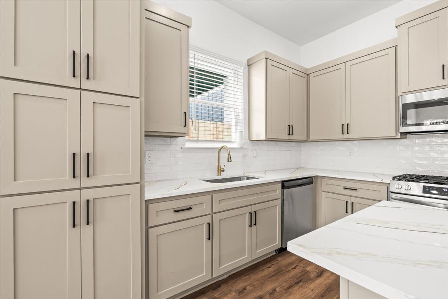 Gourmet functionality meets modern design. High-end cabinetry wraps around a gas range built for someone who loves to cook.