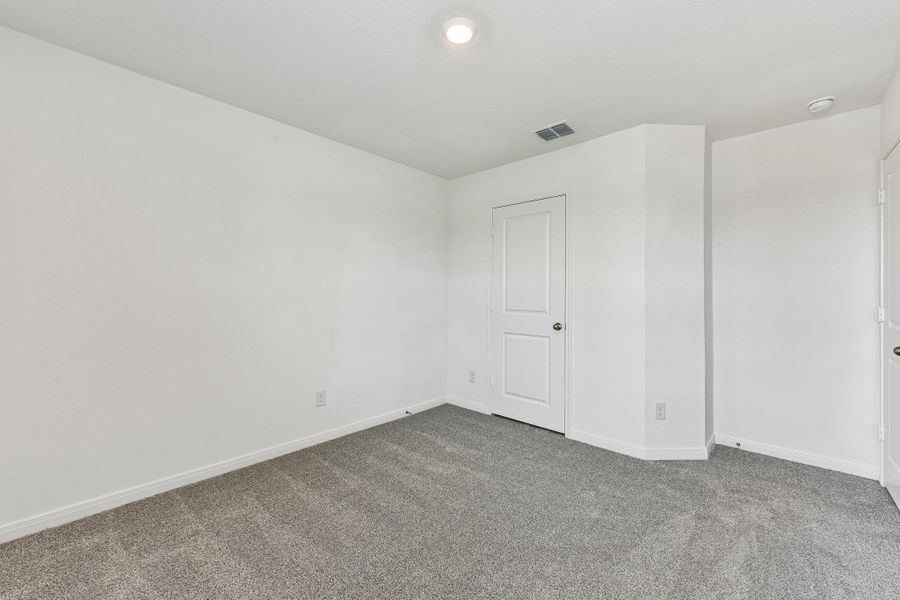 Carpeted interior space featuring white painted walls and trim