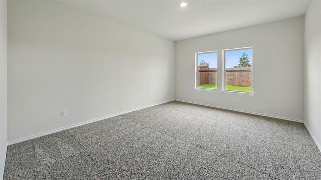 Carpeted empty room with baseboards and recessed lighting