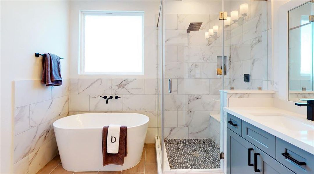 Primary Bathroom features a gorgeous freestanding tub and a separate shower with semi-frameless glass shower door. Photos from another development by Disama Construction. FINISHES & COLORS MAY VARY.