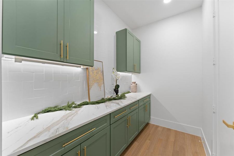 Bathroom featuring decorative backsplash, light wood finished floors, vanity, and recessed lighting