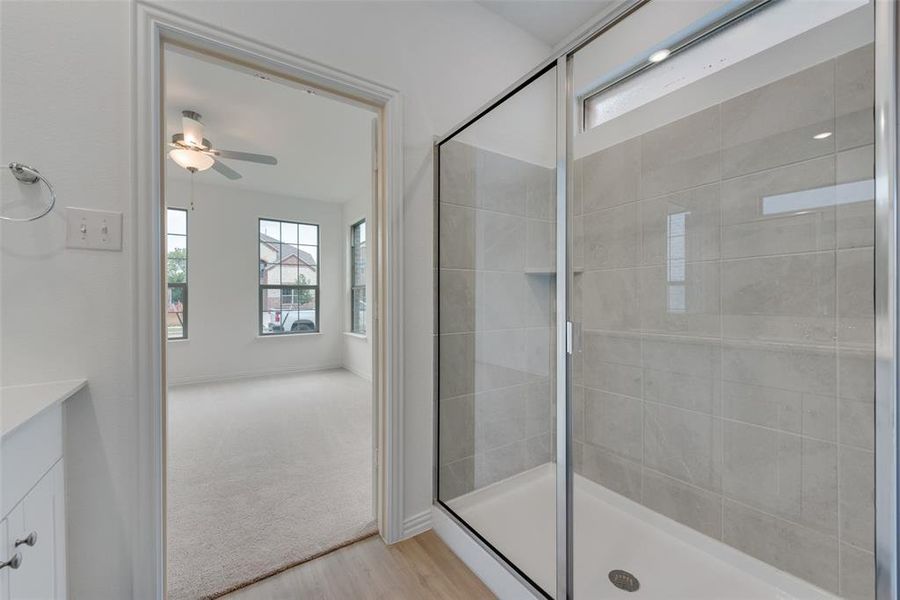 Bathroom with walk in shower, hardwood / wood-style floors, vanity, and ceiling fan