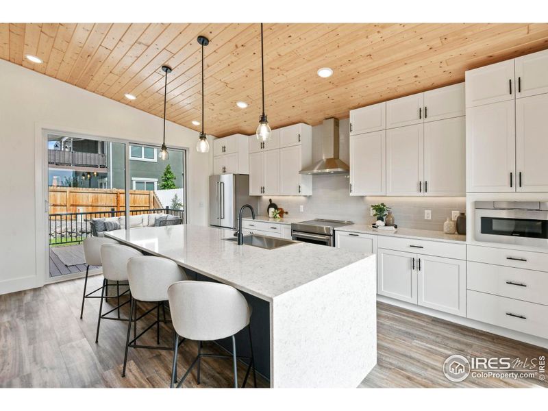 Kitchen opens to front and back decks making entertaining a dream!