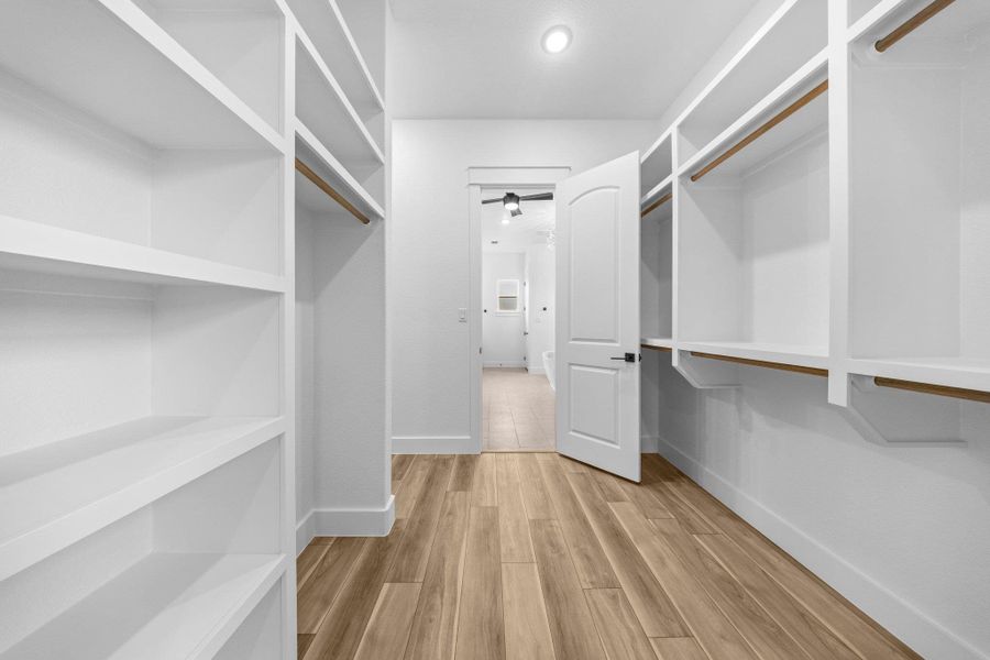 Spacious closet with wood finished floors Spacious closet with wood finished floors