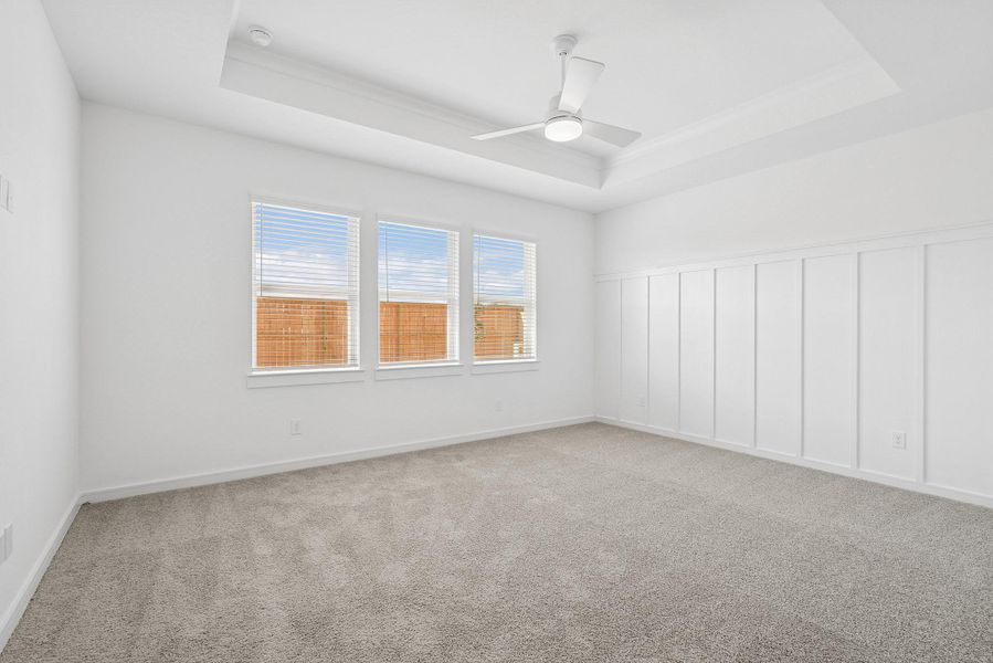 Spacious primary suite with feature wall