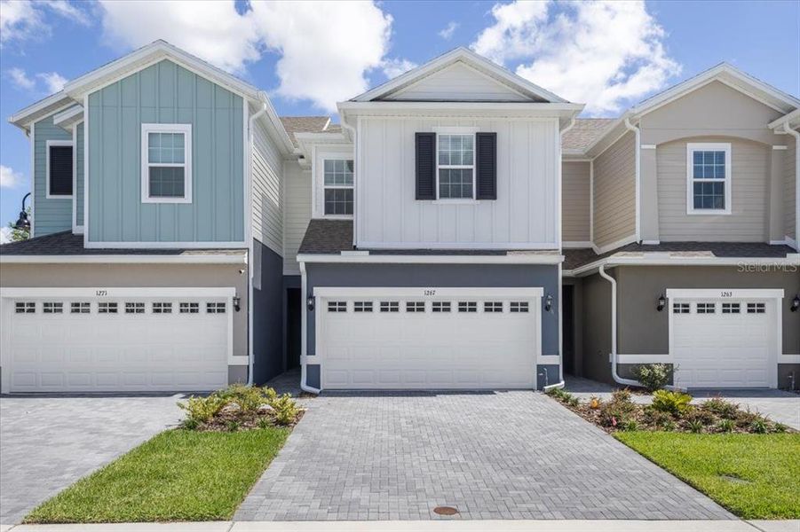 Front exterior of a new home in Brixton, St. Cloud, FL, highlighting curb appeal (Image 1).