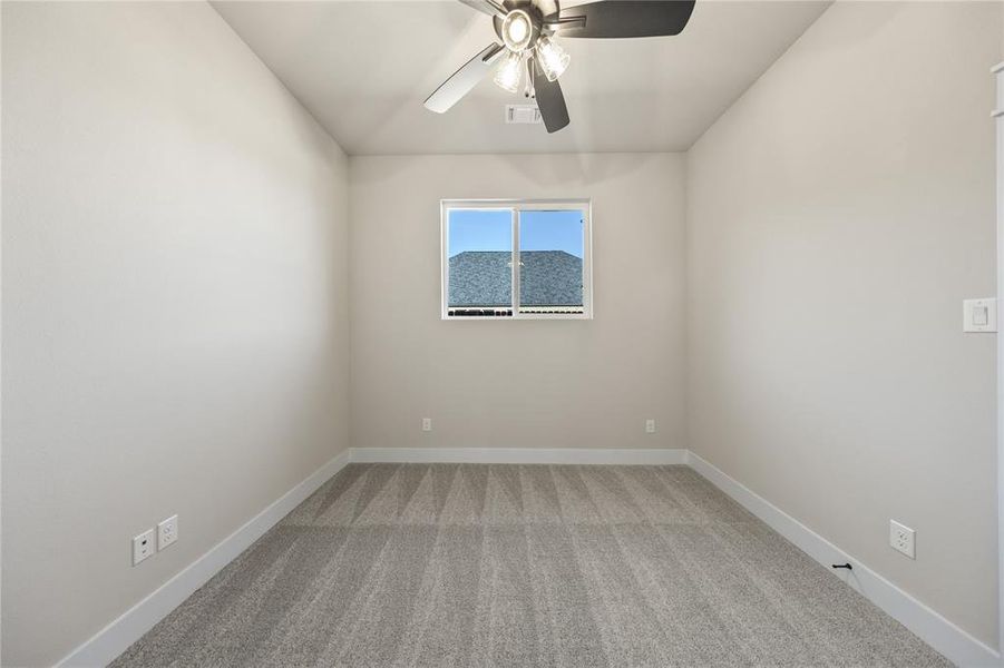 Spare room with light colored carpet and ceiling fan