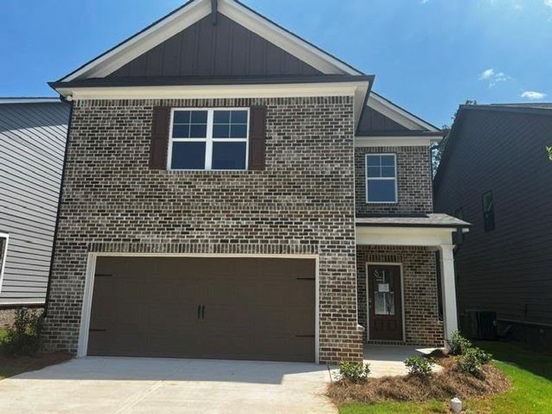 Front exterior of a new home in Crofton Place Enclave, Snellville, GA, highlighting curb appeal (Image 1). Front exterior of a new home in Crofton Place Enclave, Snellville, GA, highlighting curb appeal (Image 1).