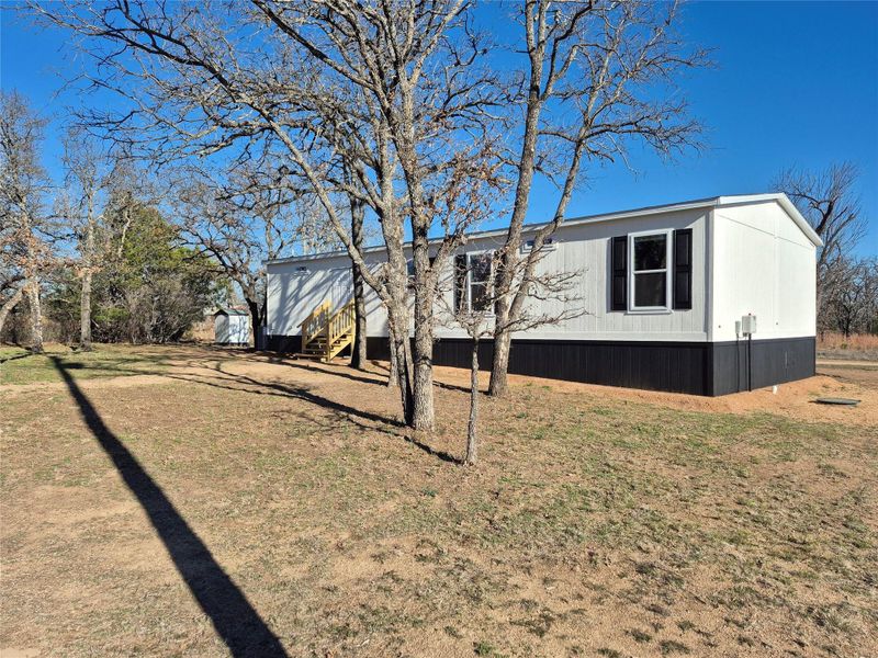 View of property exterior with a lawn