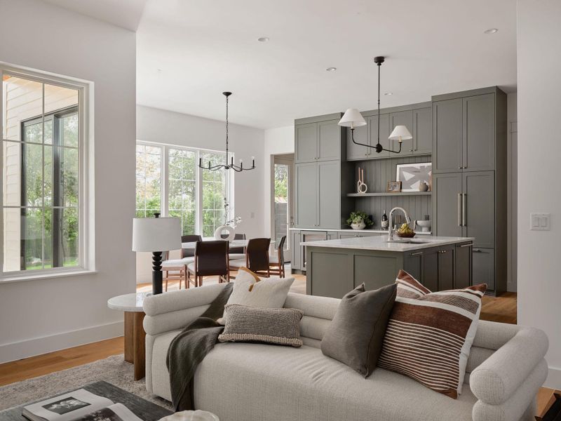 Living room with light wood finished floors, a chandelier, and recessed lighting Living room with light wood finished floors, a chandelier, and recessed lighting