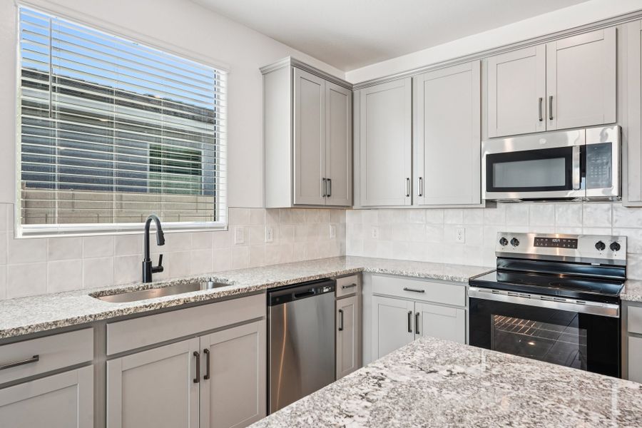 Kitchen featuring the Artisan Collection. Finishes may vary by community.