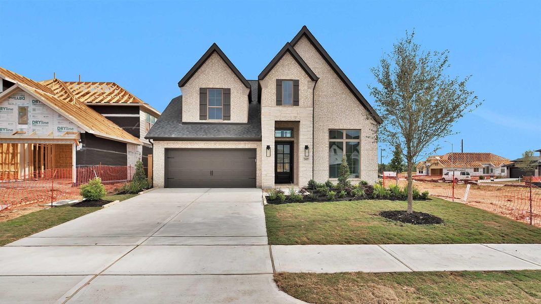 Front exterior of a new home in Candela, Richmond, TX, highlighting curb appeal (Image 2).