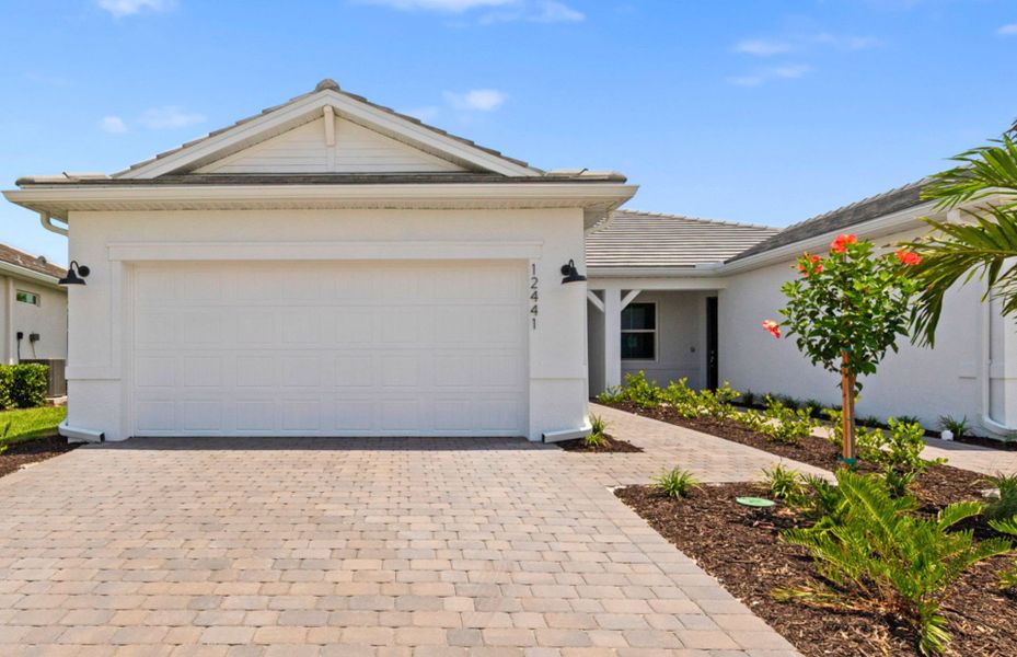 Front exterior of a new home in TerraWalk at Babcock Ranch, Alva, FL, highlighting curb appeal (Image 1). Front exterior of a new home in TerraWalk at Babcock Ranch, Alva, FL, highlighting curb appeal (Image 1).