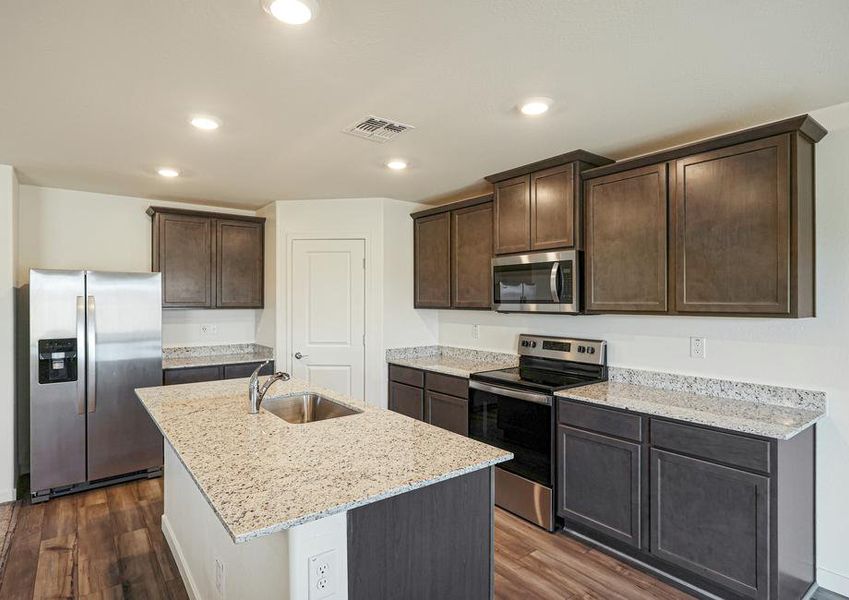 Enjoy stunning granite countertops and designer wood cabinetry in this kitchen.