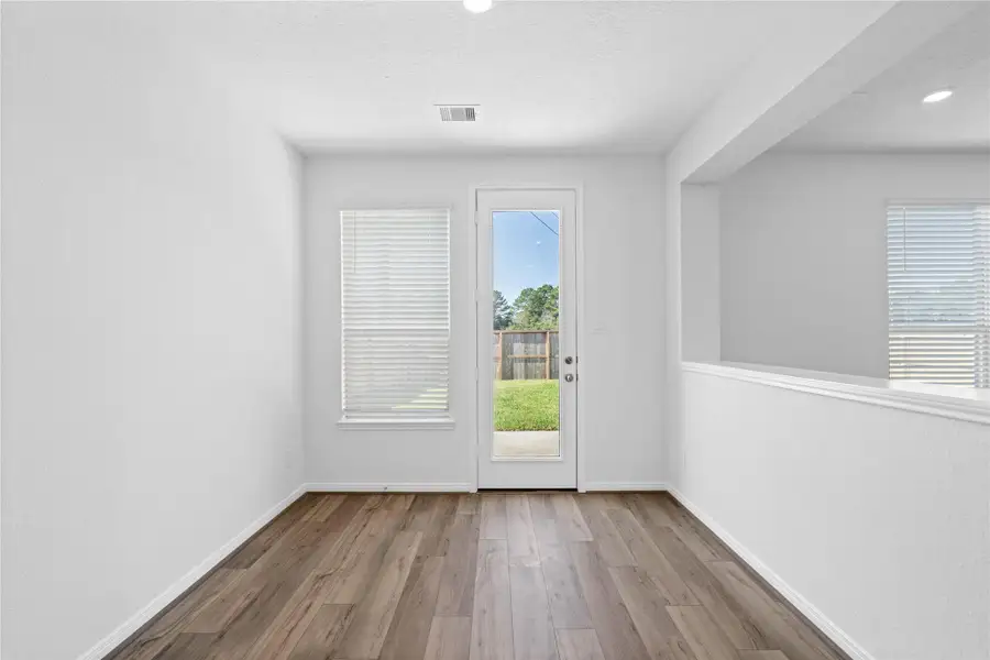 Start your day with a warm cup of coffee and quality time in this charming nook! Highlights include a large window, custom neutral paint, vinyl plank flooring, recessed lighting, high ceilings, and a convenient door leading to the rear patio and backyard. Start your day with a warm cup of coffee and quality time in this charming nook! Highlights include a large window, custom neutral paint, vinyl plank flooring, recessed lighting, high ceilings, and a convenient door leading to the rear patio and backyard.