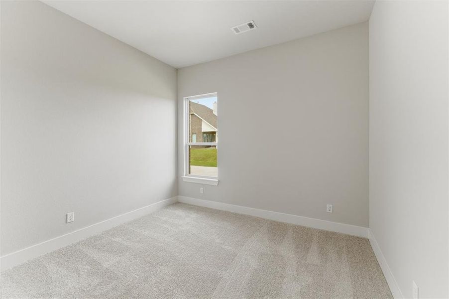 Unfurnished room with light carpet and baseboards
