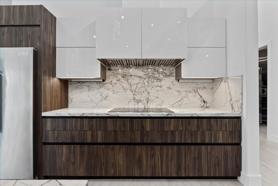 Culinary perfection. The main gourmet kitchen features imported Italian cabinetry. All soft close drawers and cabinets as well as Altaeuro frameless cabinets.