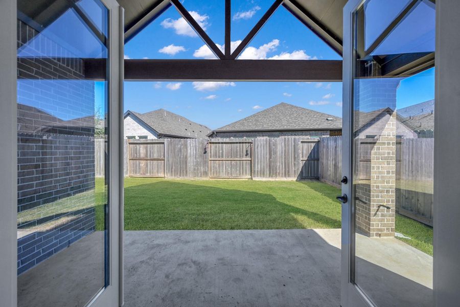 The double French doors open to the spacious covered patio with a vaulted ceiling. There is a gas stub already installed for your gas grill or summer kitchen.