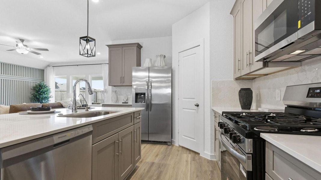 Kitchen adorned with painted cabinets seamlessly integrated into an open dining area layout. Kitchen adorned with painted cabinets seamlessly integrated into an open dining area layout.