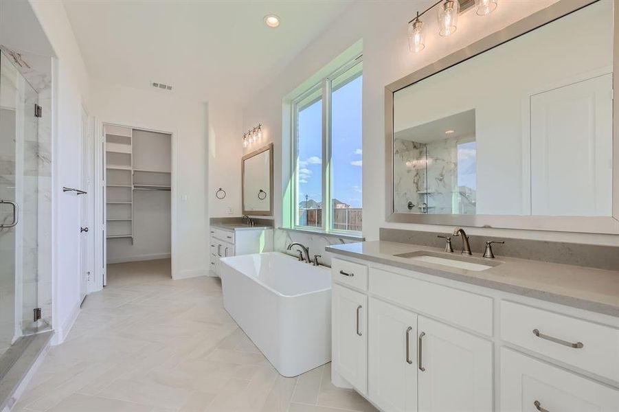 Bathroom featuring vanity and plus walk in shower