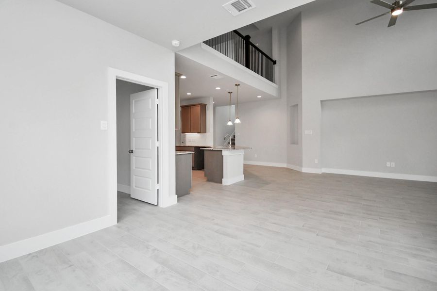 View from the breakfast area to the kitchen and living room. Sample photo of completed home with similar floor plan. Actual colors and selections may vary. View from the breakfast area to the kitchen and living room. Sample photo of completed home with similar floor plan. Actual colors and selections may vary.