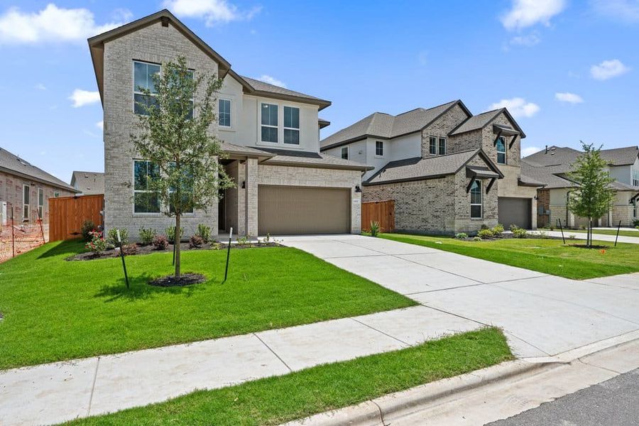 Front exterior of a new home in Lariat, Liberty Hill, TX, highlighting curb appeal (Image 23). Front exterior of a new home in Lariat, Liberty Hill, TX, highlighting curb appeal (Image 23).