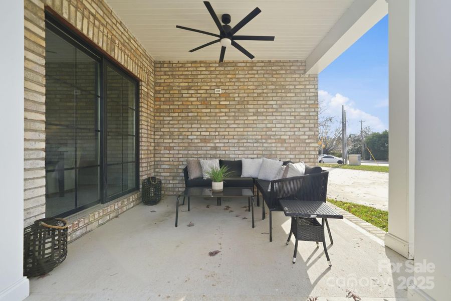 Covered porch seating with modern ceiling fan — the ideal spot for relaxing or entertaining. Covered porch seating with modern ceiling fan — the ideal spot for relaxing or entertaining.