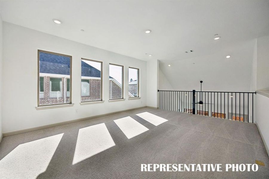 Spacious and flooded with natural light, this wonderful game room is the perfect place to host those big game day parties!  REPRESENTATIVE PHOTO