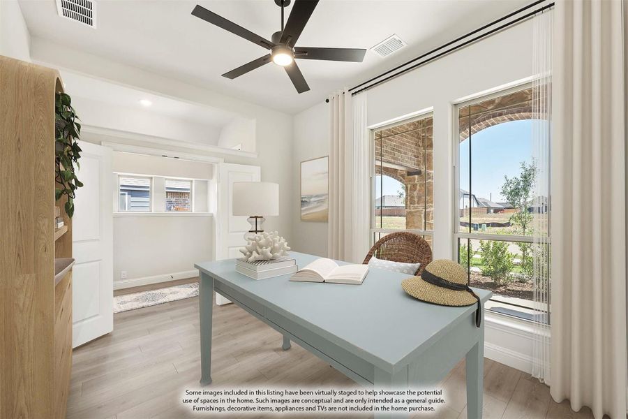 Home office with light blue desk, ceiling fan, hardwood floors, and large windows with outdoor view Home office with light blue desk, ceiling fan, hardwood floors, and large windows with outdoor view