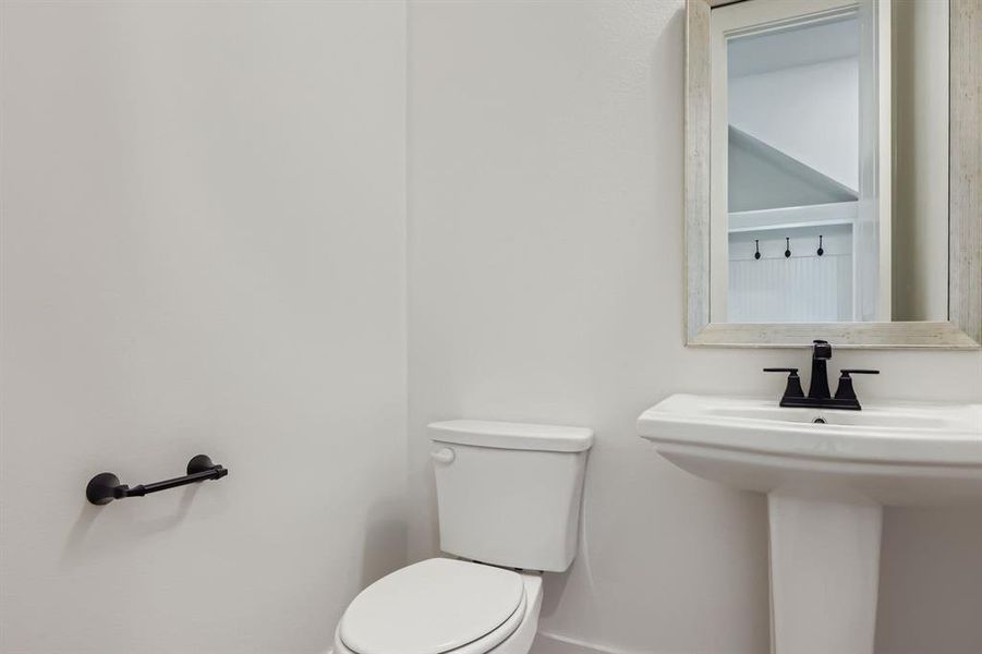 Bathroom featuring toilet and baseboards Bathroom featuring toilet and baseboards