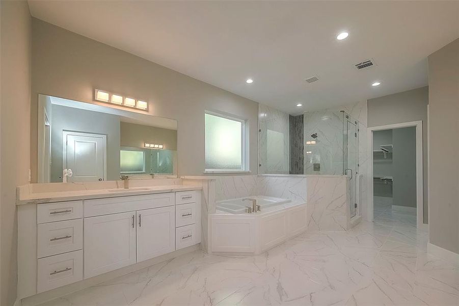 Luxury primary bathroom with his and her vanity