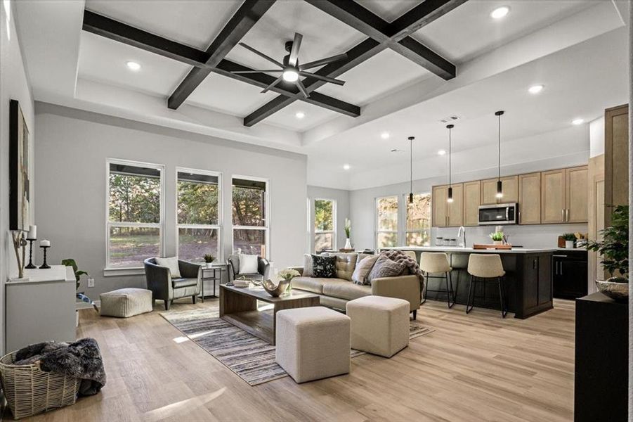 Living room with coffered ceiling, ceiling fan, sink, light hardwood / wood-style flooring, and beamed ceiling