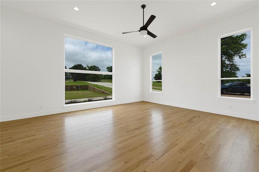 Unfurnished room featuring ceiling fan, light wood-style floors, baseboards, and recessed lighting Unfurnished room featuring ceiling fan, light wood-style floors, baseboards, and recessed lighting