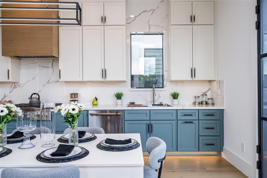 Enjoy two-tone custom cabinetry in designer hues, luxurious porcelain countertops, and full-height backsplash. A glass-framed pantry with interior countertop and GE Café appliances complete this dream kitchen Enjoy two-tone custom cabinetry in designer hues, luxurious porcelain countertops, and full-height backsplash. A glass-framed pantry with interior countertop and GE Café appliances complete this dream kitchen