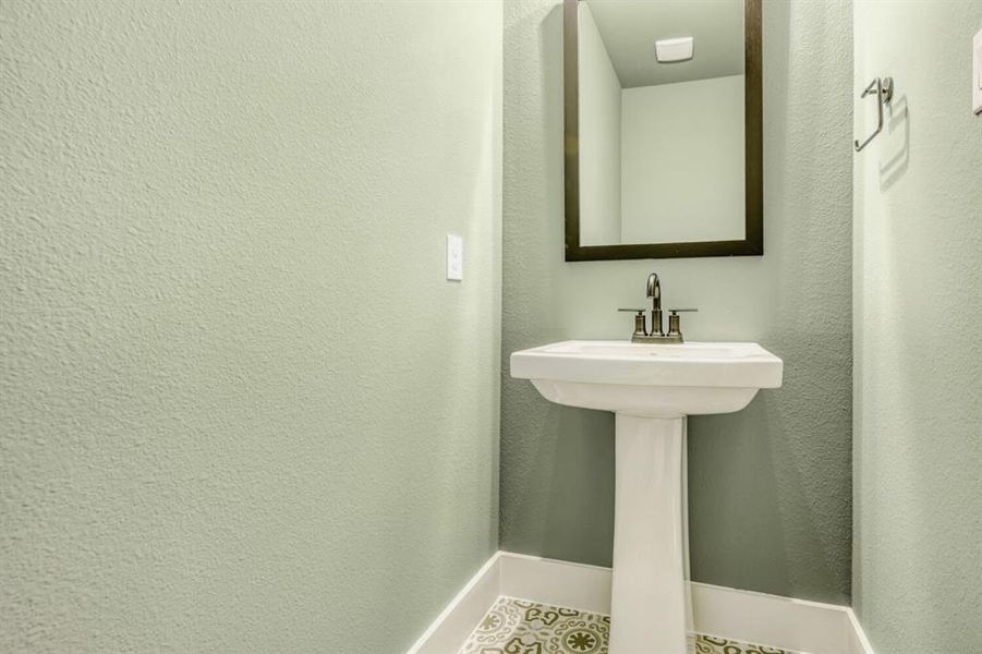 Bathroom featuring baseboards and tile patterned flooring