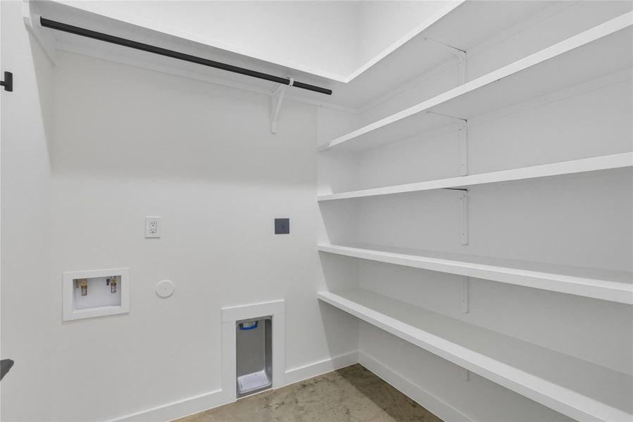 Laundry room with Washer dryer hookup clothing rod and storage shelves Laundry room with Washer dryer hookup clothing rod and storage shelves