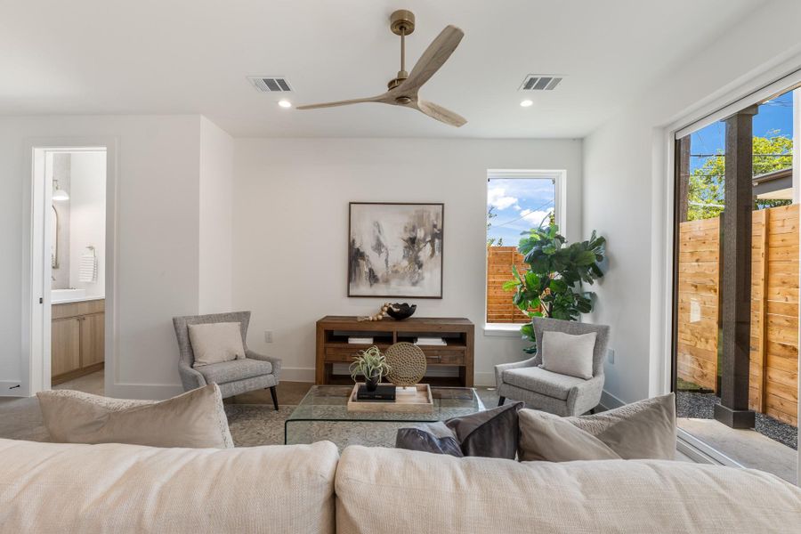 The open-concept living room connects effortlessly to the kitchen, powder bath, and backyard, creating an easy flow for both daily life and entertaining.