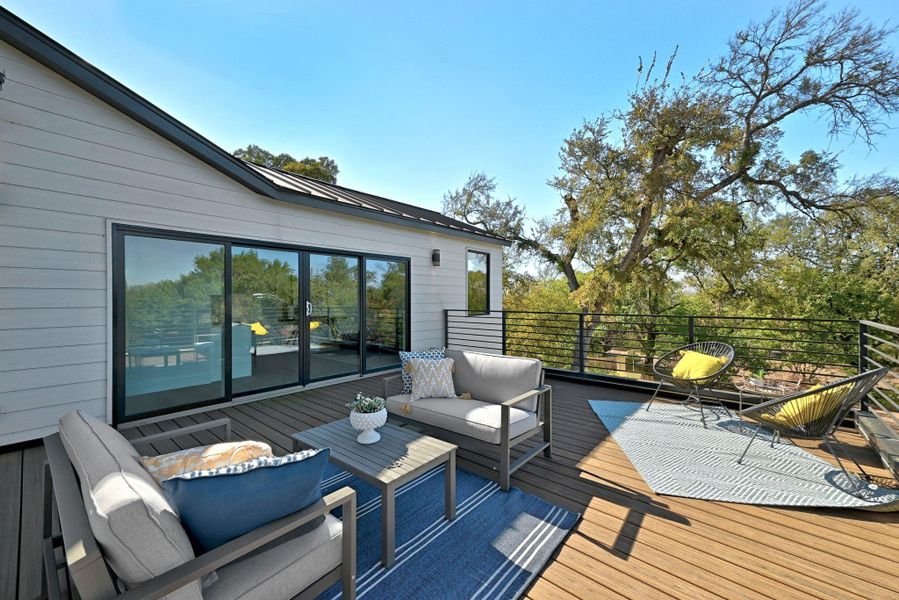 Private deck off of flex space with an outdoor living space plus tree top views Private deck off of flex space with an outdoor living space plus tree top views