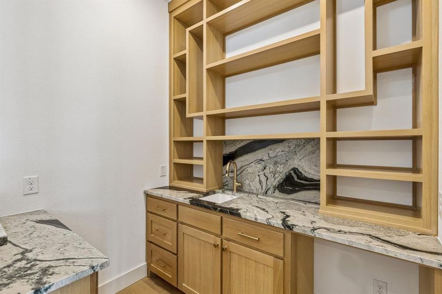 With a wet bar located just across from the media room, entertaining is a breeze in this beautiful home!