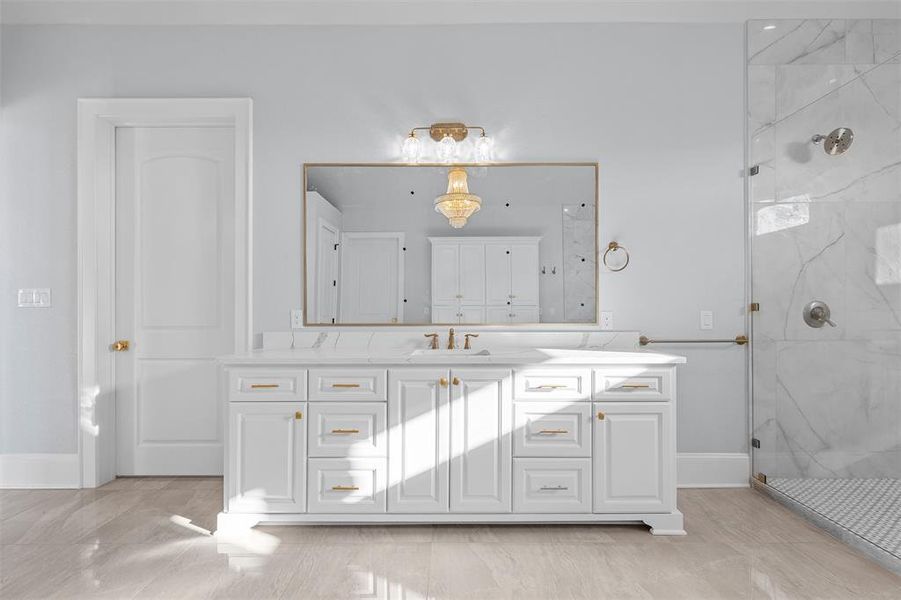 Bathroom with a marble finish shower and vanity Bathroom with a marble finish shower and vanity