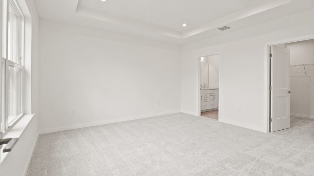 Spacious primary Suite with en suite bath and walk-in closet in the Flagler by DRB Homes in Hamilton Bluff Spacious primary Suite with en suite bath and walk-in closet in the Flagler by DRB Homes in Hamilton Bluff