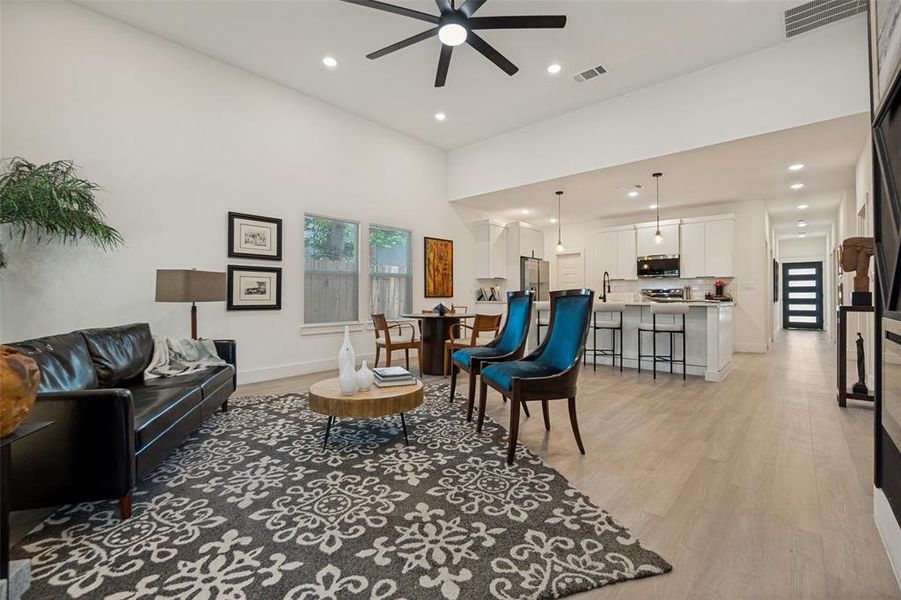 Vaulted ceilings accent an open-concept living space with light wood-finish flooring Vaulted ceilings accent an open-concept living space with light wood-finish flooring