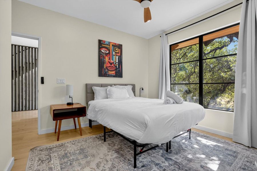 Bedroom with light wood-type flooring and a ceiling fan