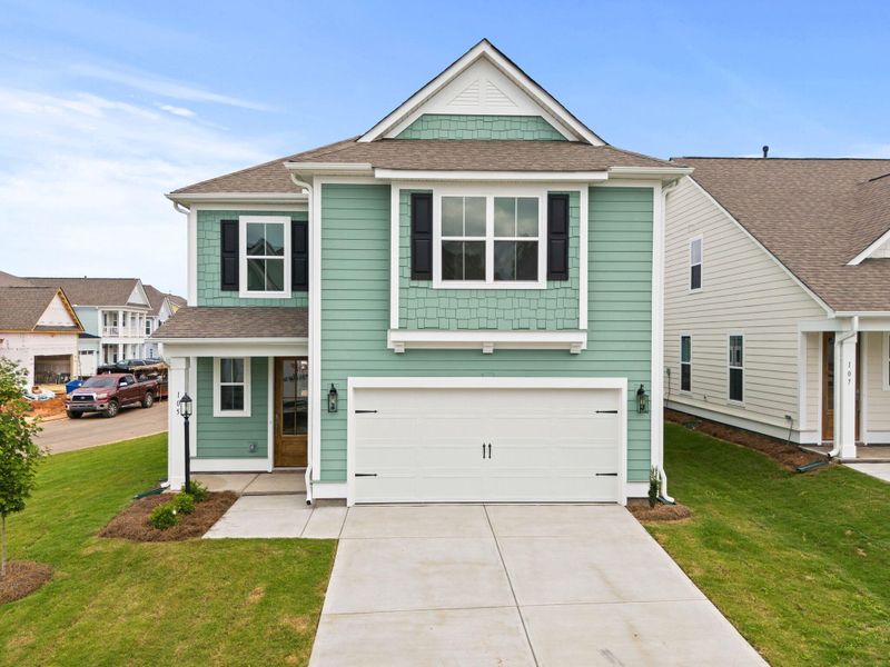 Front exterior of a new home in Sweetgrass Station, Summerville, SC, highlighting curb appeal (Image 1).