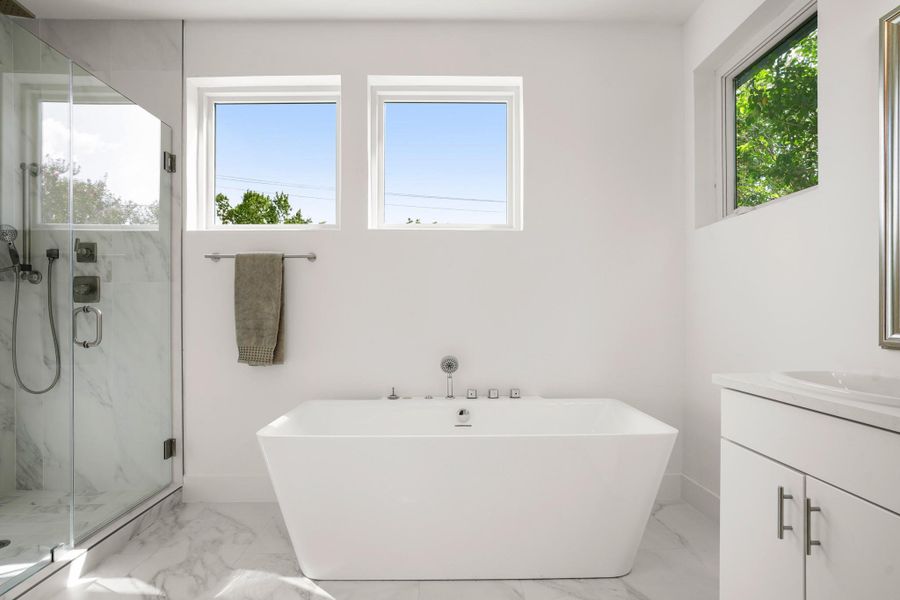 Marble flooring and a spacious soaking tub define this elegant bathroom retreat. Marble flooring and a spacious soaking tub define this elegant bathroom retreat.
