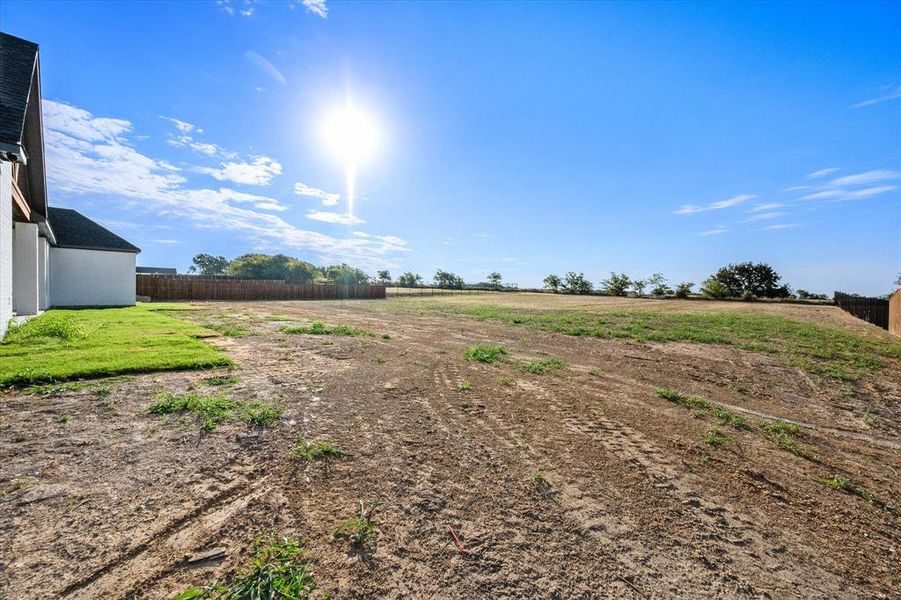 View of yard with a rural view