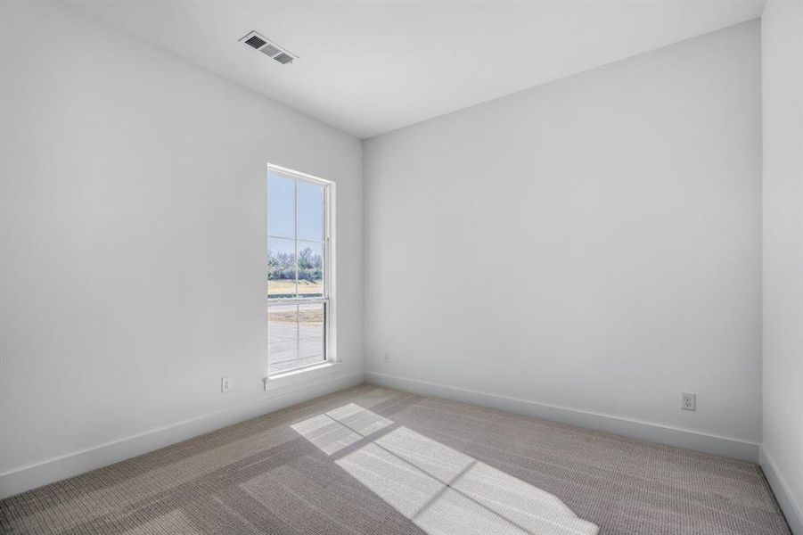 Carpeted empty room featuring baseboards